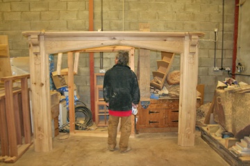 003-large-oak-fireplace-in-workshop-man-standing-in-centre-for-size