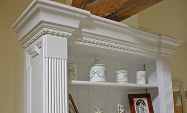 Close up of reeded columns and moulded cornice on fitted bathroom cabinets