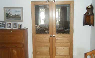 /bespoke internal double door in ash wood with glass panes at the top of the door