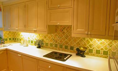 Corian worktops, hob embedded in worktop and down lighters fitted under cupboards