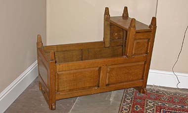 Handmade old fashion style oak baby rocking cradle with raised panels and head nest